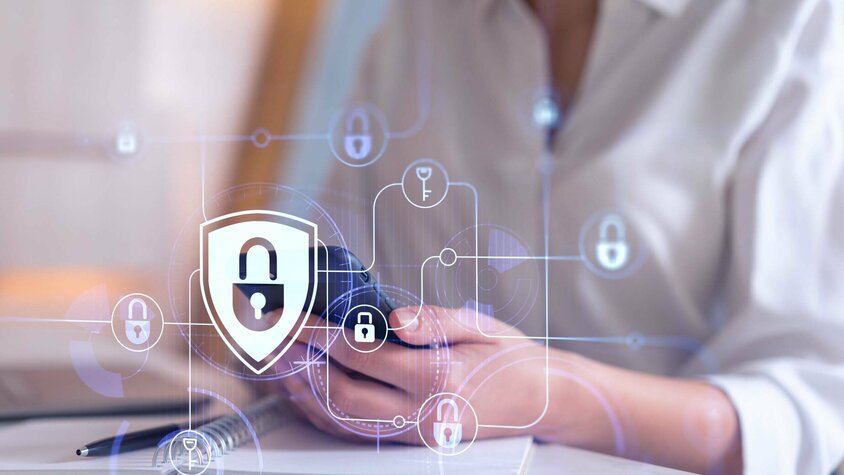 Geschäftsethik und Verhaltenskodex - Datenschutz und Umgang mit Informationen Eine Frau hält ein Handy in der Hand, über dessen Foto verschiedene Sicherheitssymbole eingeblendet sind, was den Fokus auf Sicherheit und Technologie legt. In der Geschäftsethik von weba Werkzeugbau symbolisiert dieses Bild den Datenschutz und Umfang mit Informationen.